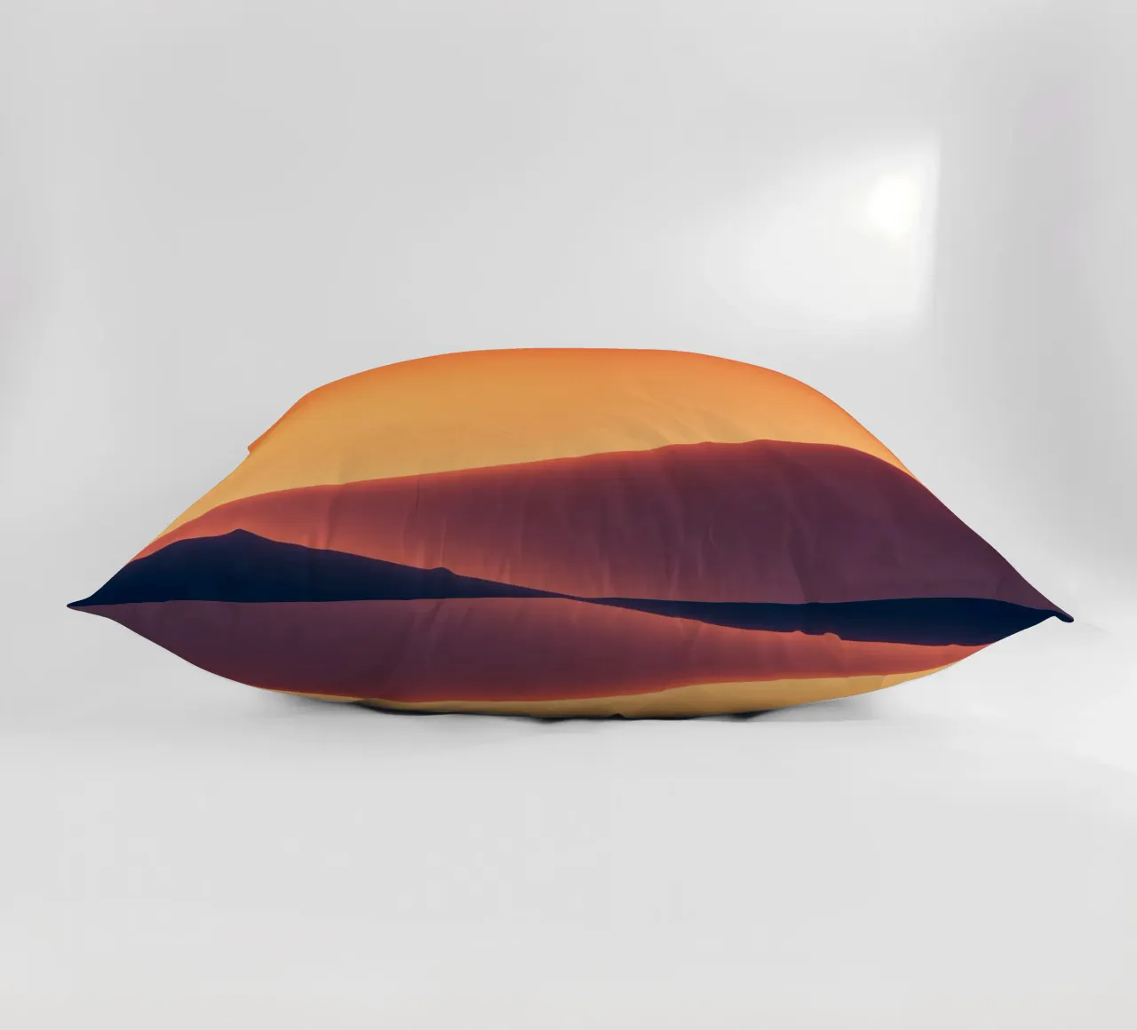 smooth hills under a gradient sunset sky with warm orange decorative cushion by DesignDoodle