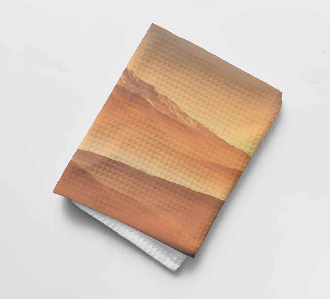 Majestic mountains shrouded in mist during golden hour tea towel by DesignDoodle