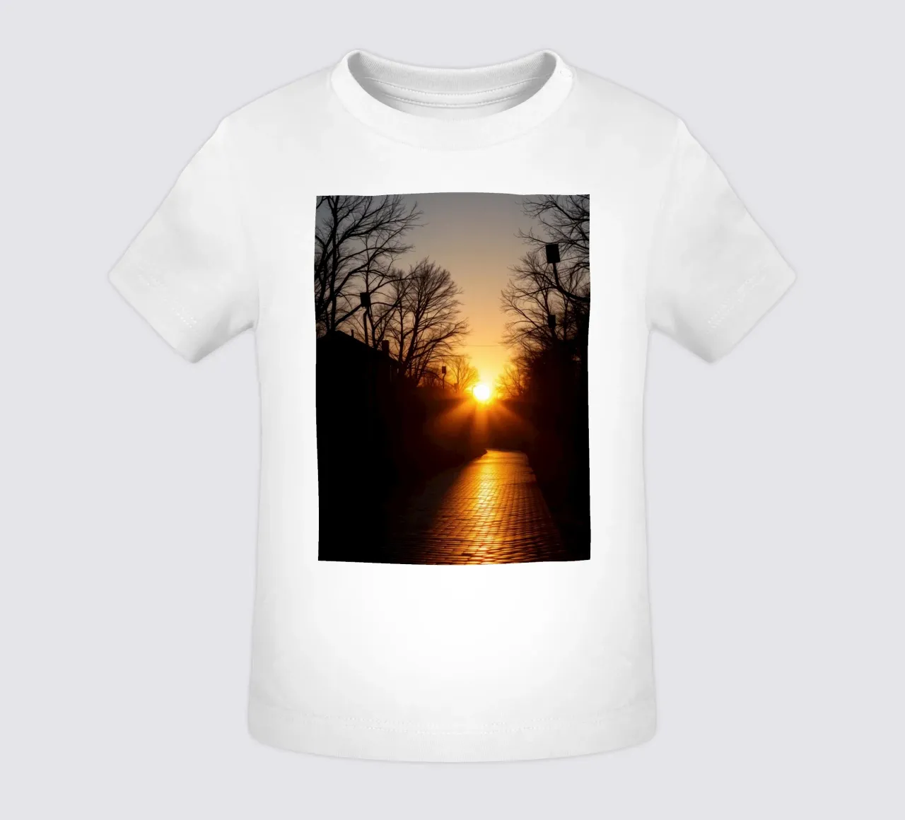 Sunset view along a tree-lined pathway with warm hues baby t-shirt by DesignDoodle