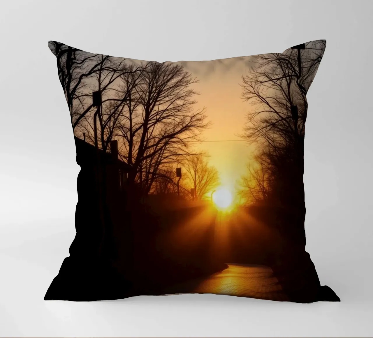 Sunset view along a tree-lined pathway with warm hues decorative cushion by DesignDoodle