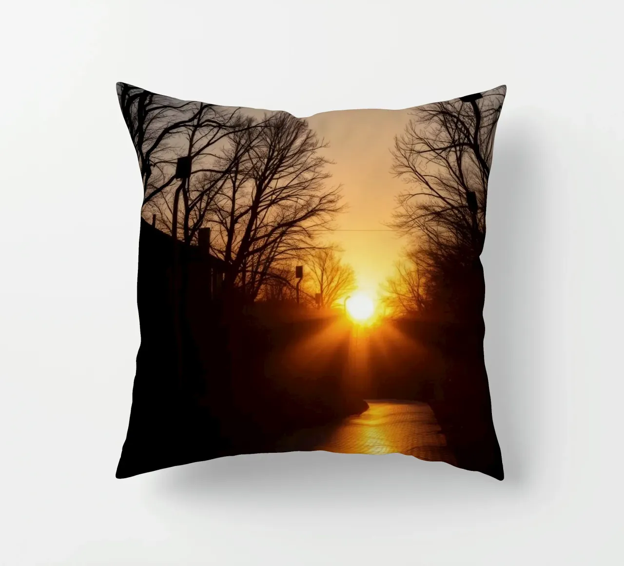 Sunset view along a tree-lined pathway with warm hues decorative cushion by DesignDoodle