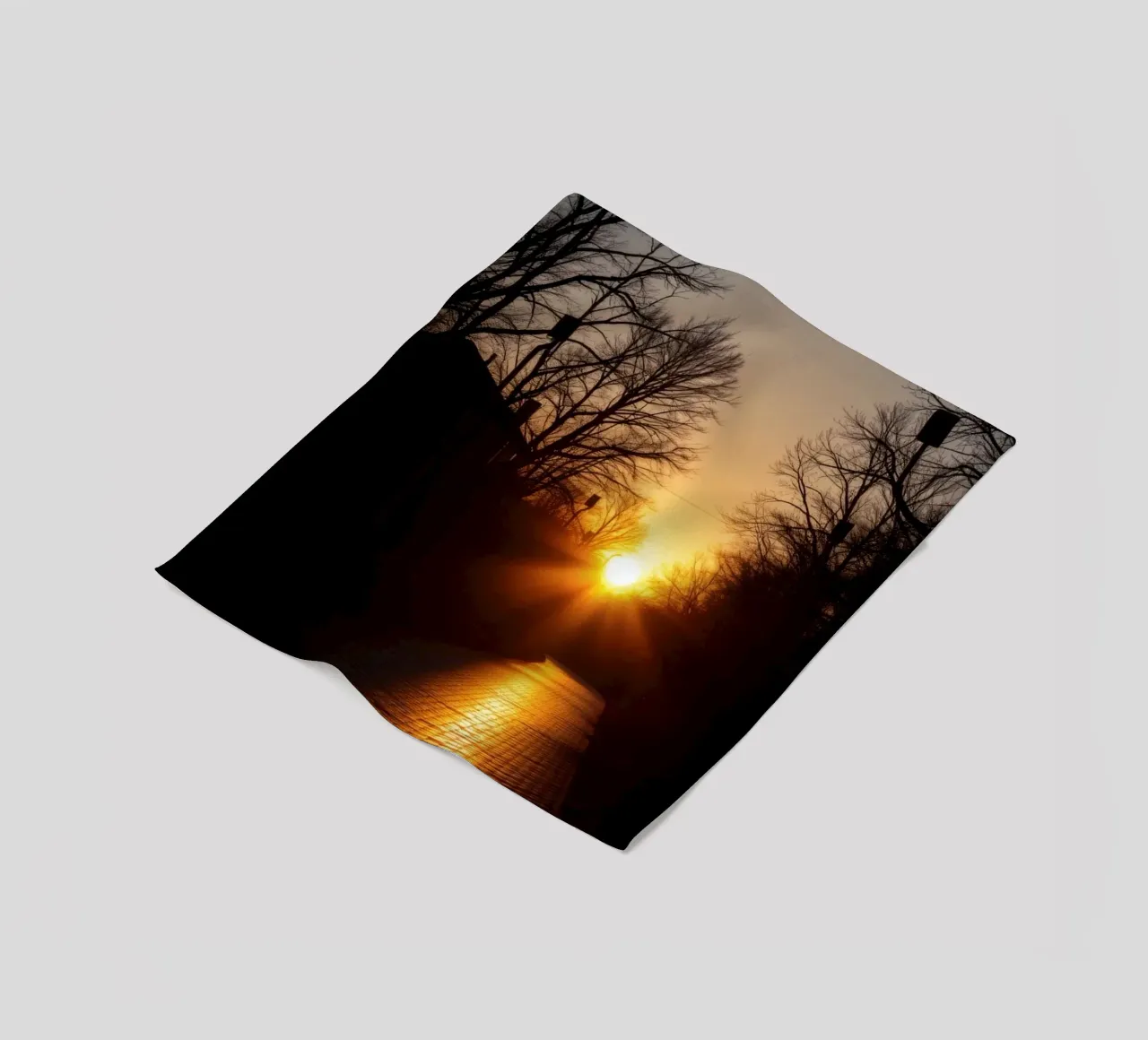Sunset view along a tree-lined pathway with warm hues fleece blanket by DesignDoodle