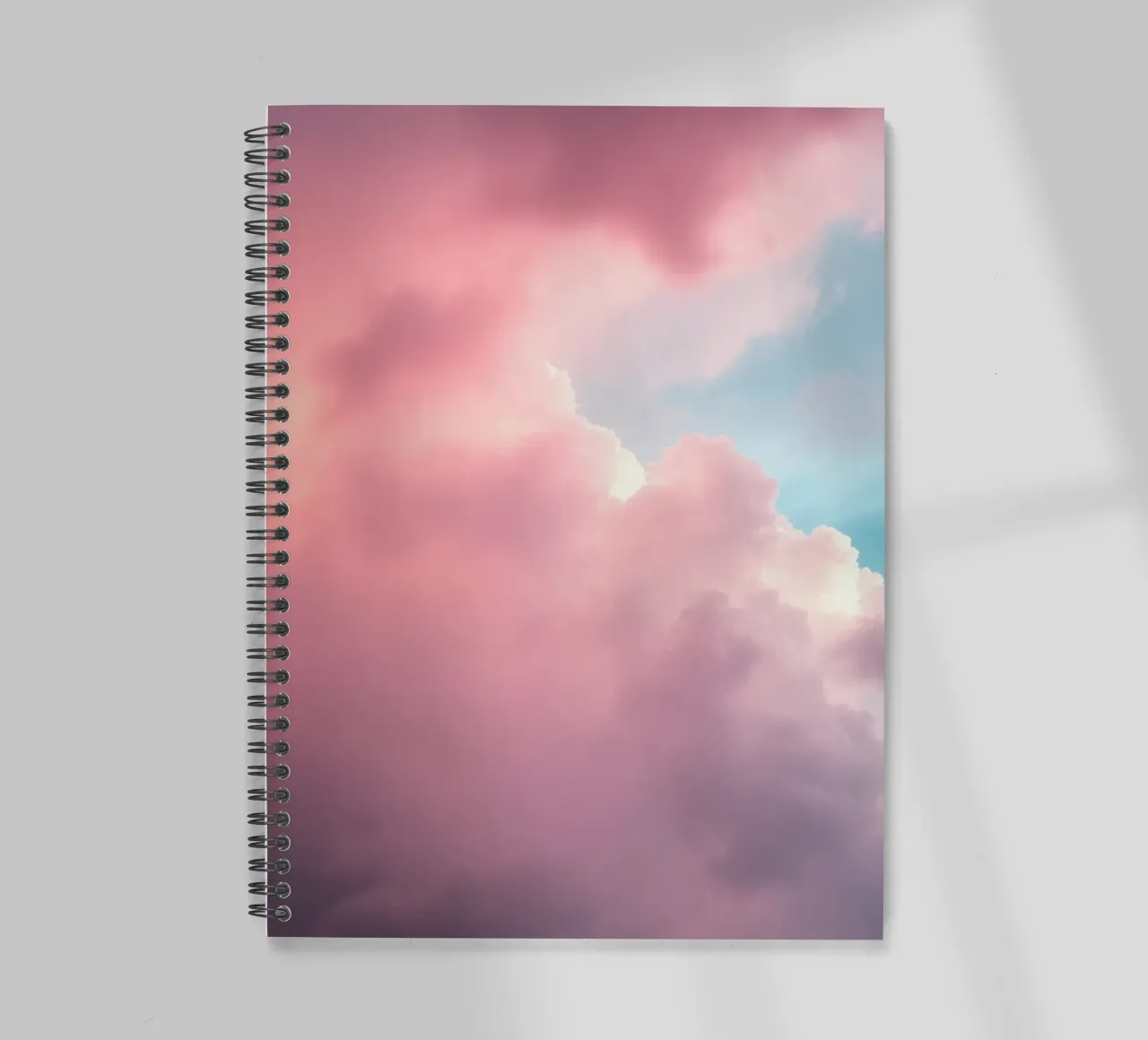 Vibrant cloud formations create a stunning abstract spiral notebook by DesignDoodle