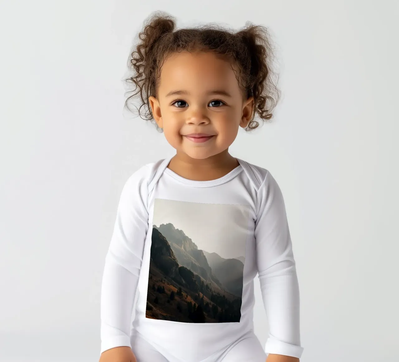 Vue majestueuse sur les montagnes avec des sommets embrumés sous un doux soleil body manches longues de DesignDoodle