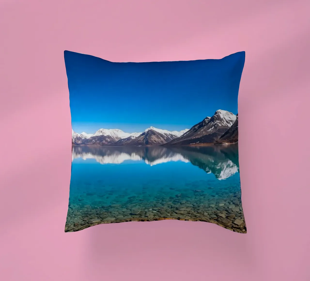 view of a serene lake surrounded by snow-capped mountains decorative cushion by DesignDoodle