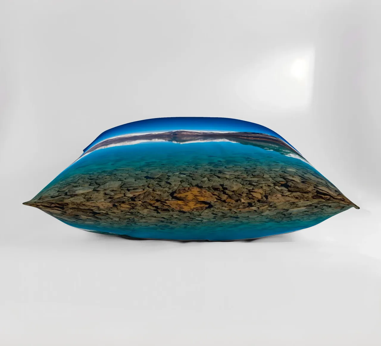 view of a serene lake surrounded by snow-capped mountains decorative cushion by DesignDoodle