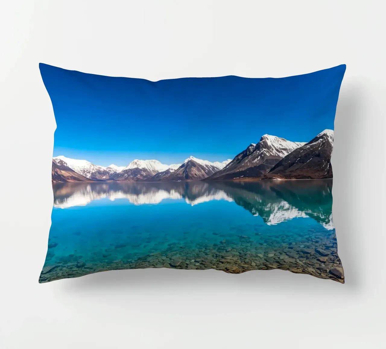 view of a serene lake surrounded by snow-capped mountains decorative cushion by DesignDoodle