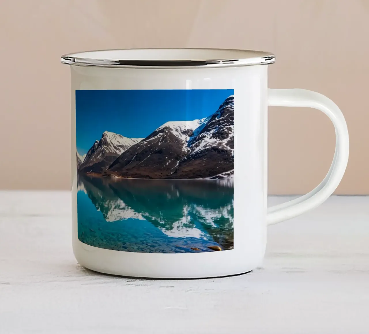 view of a serene lake surrounded by snow-capped mountains enamel mug by DesignDoodle
