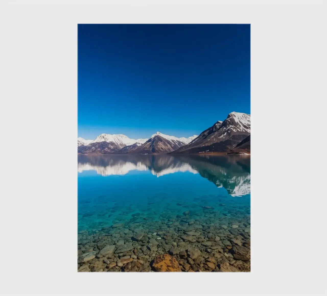 view of a serene lake surrounded by snow-capped mountains notebook by DesignDoodle