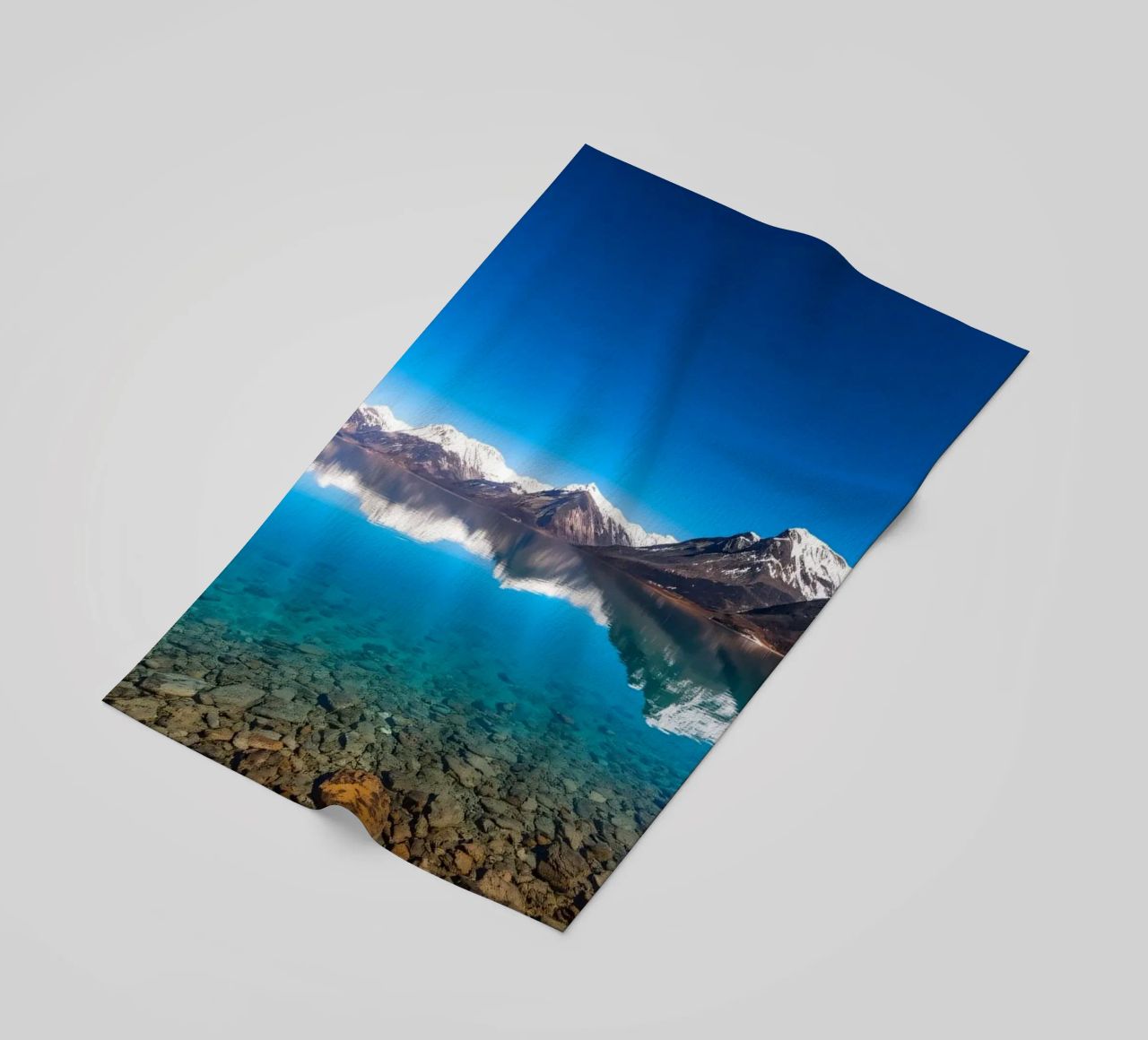 vue sur un lac serein entouré de montagnes enneigées serviette de plage de DesignDoodle