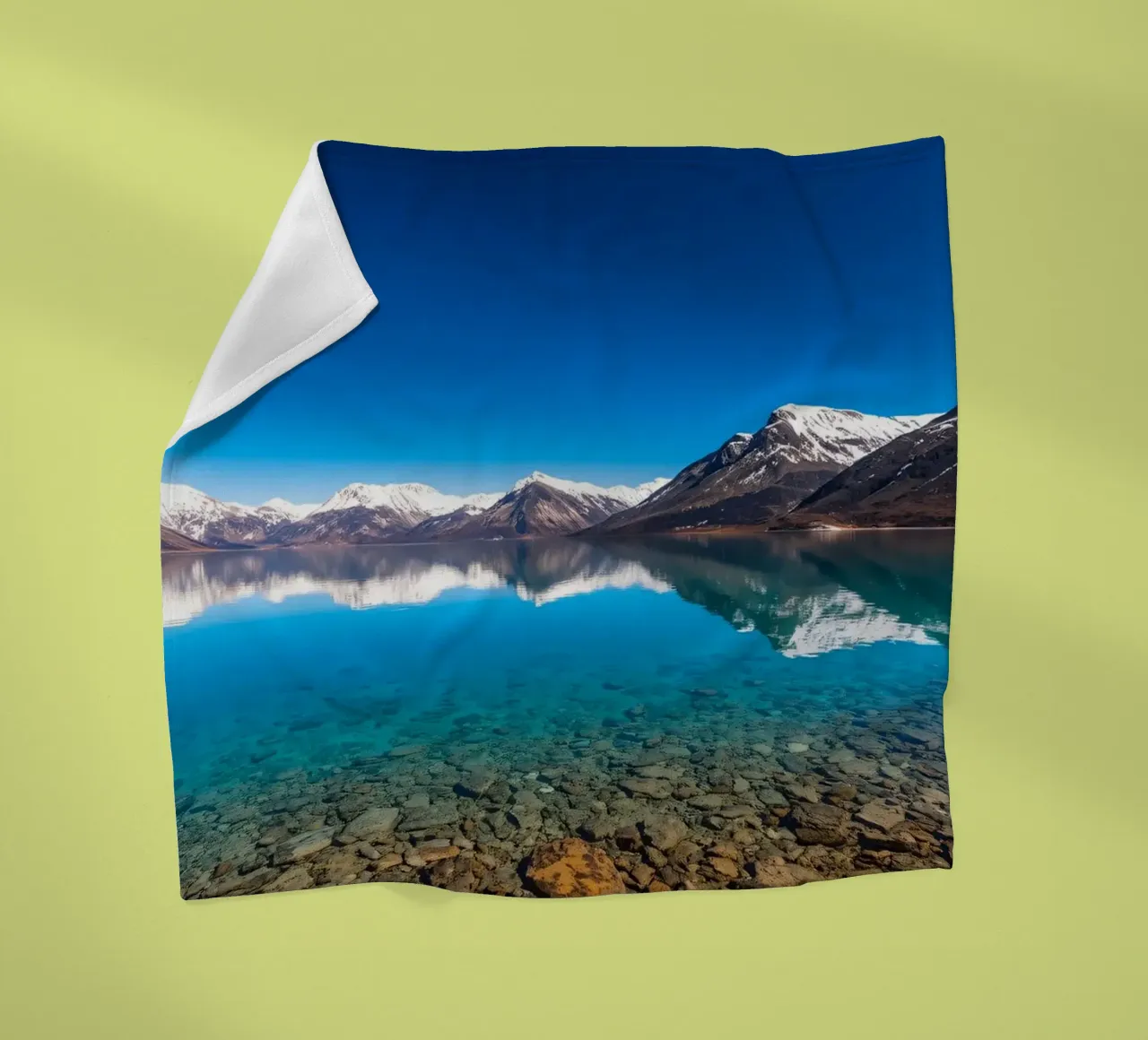 view of a serene lake surrounded by snow-capped mountains fleece blanket by DesignDoodle