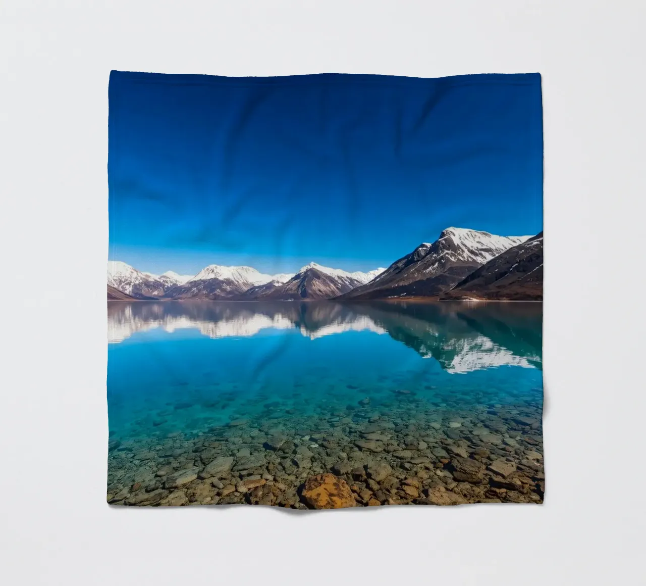 view of a serene lake surrounded by snow-capped mountains fleece blanket by DesignDoodle