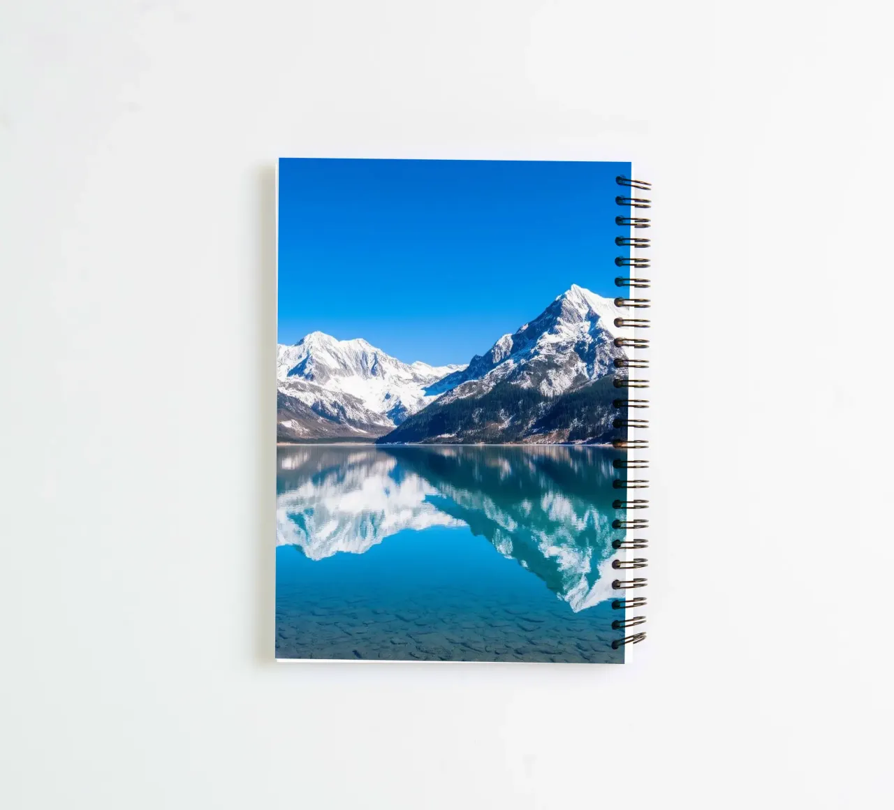 Stunning reflection of snow-capped mountains in a tranquil spiral notebook by DesignDoodle