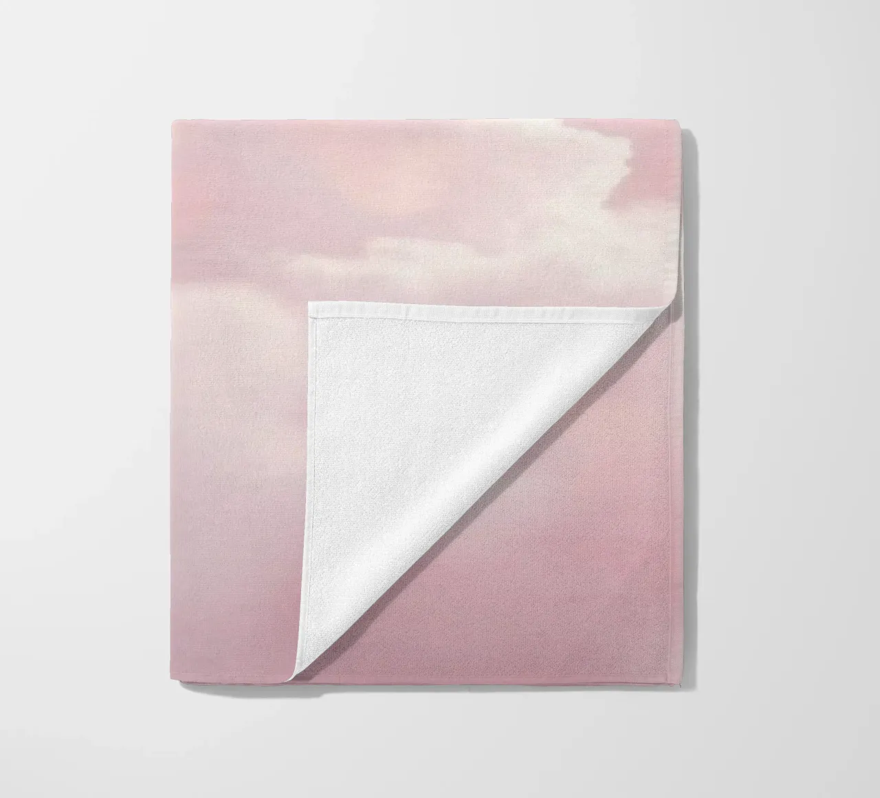 Soft pastel clouds create a serene abstract background beach towel by DesignDoodle