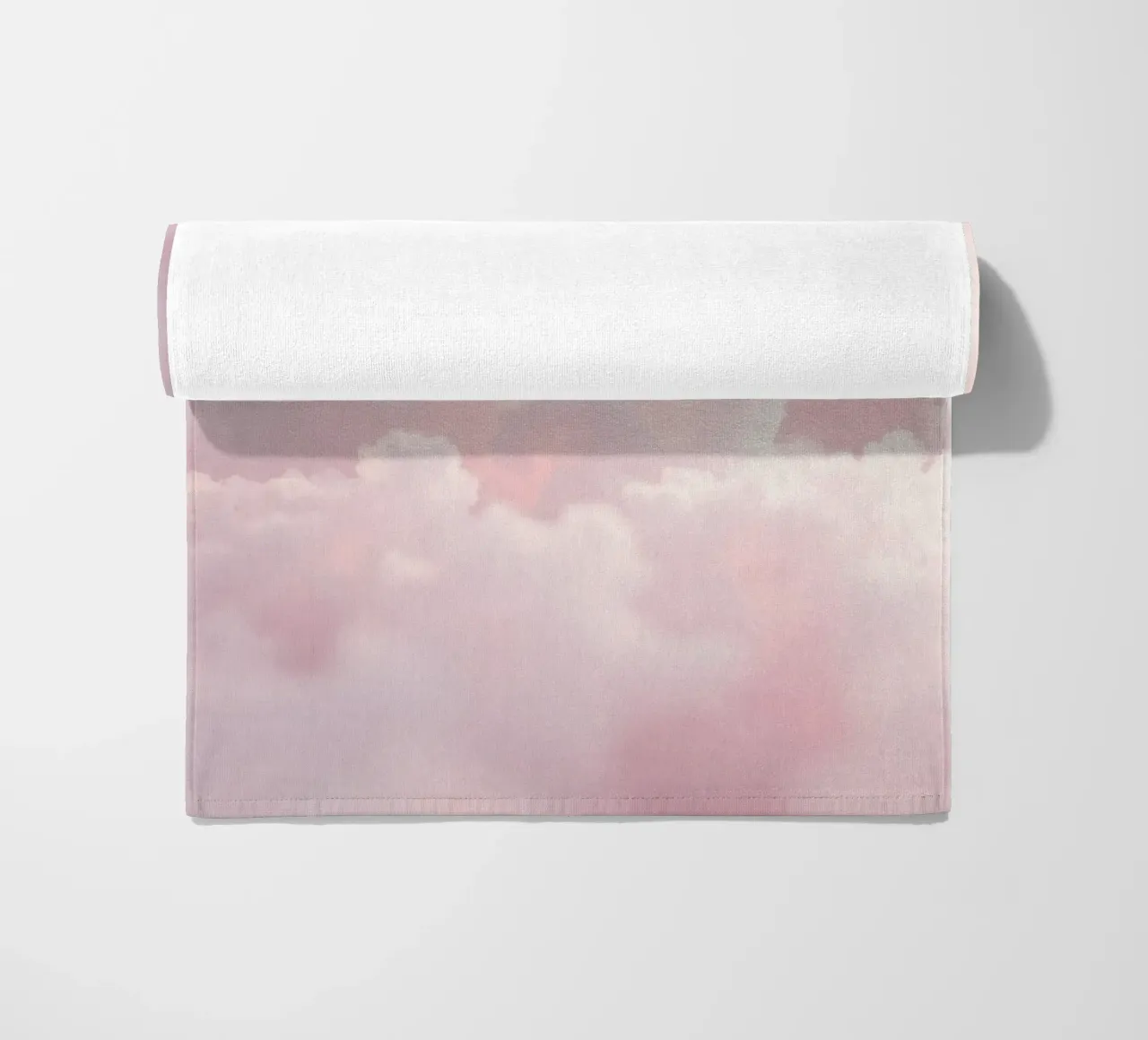 Soft pastel clouds create a serene abstract background beach towel by DesignDoodle