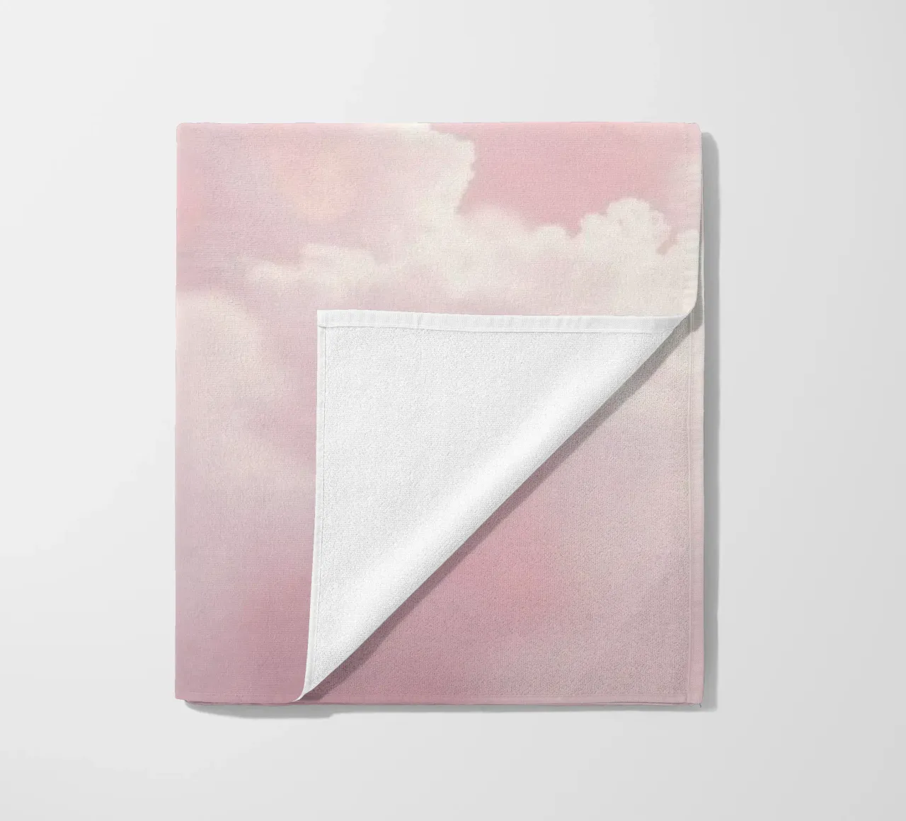 Soft pastel clouds create a serene abstract background beach towel by DesignDoodle