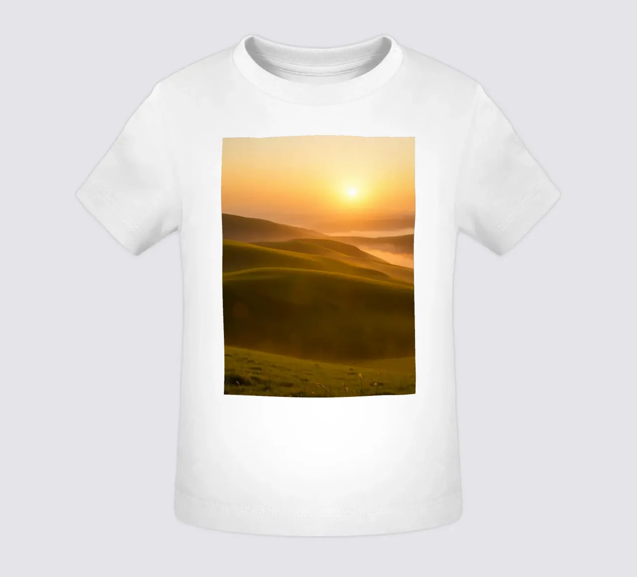 Sunset over rolling green hills with mist creating a serene baby t-shirt by DesignDoodle