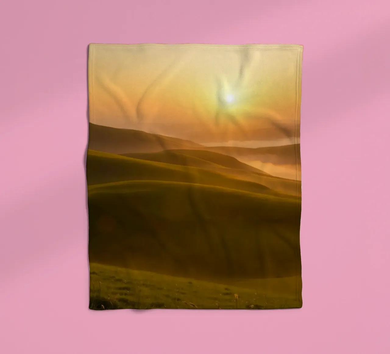 Sunset over rolling green hills with mist creating a serene fleece blanket by DesignDoodle