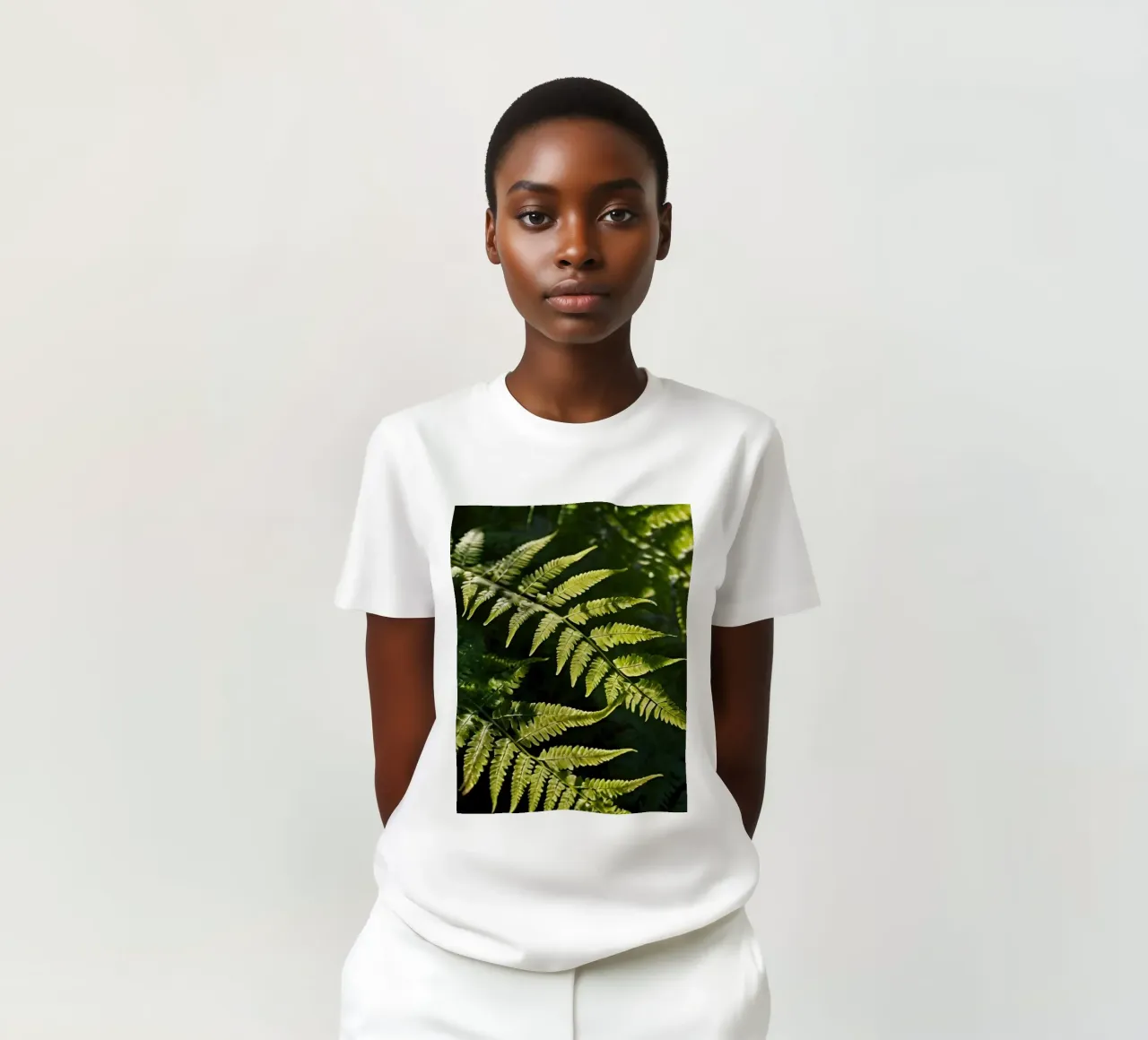 Sunlight filters through lush green ferns in a tranquil fore t-shirt by DesignDoodle
