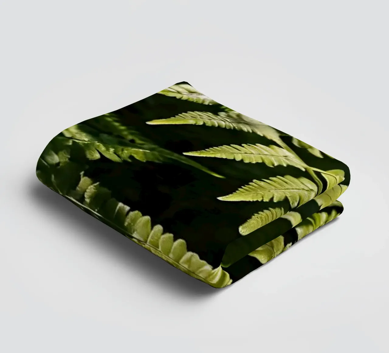 Sunlight filters through lush green ferns in a tranquil fore towel by DesignDoodle