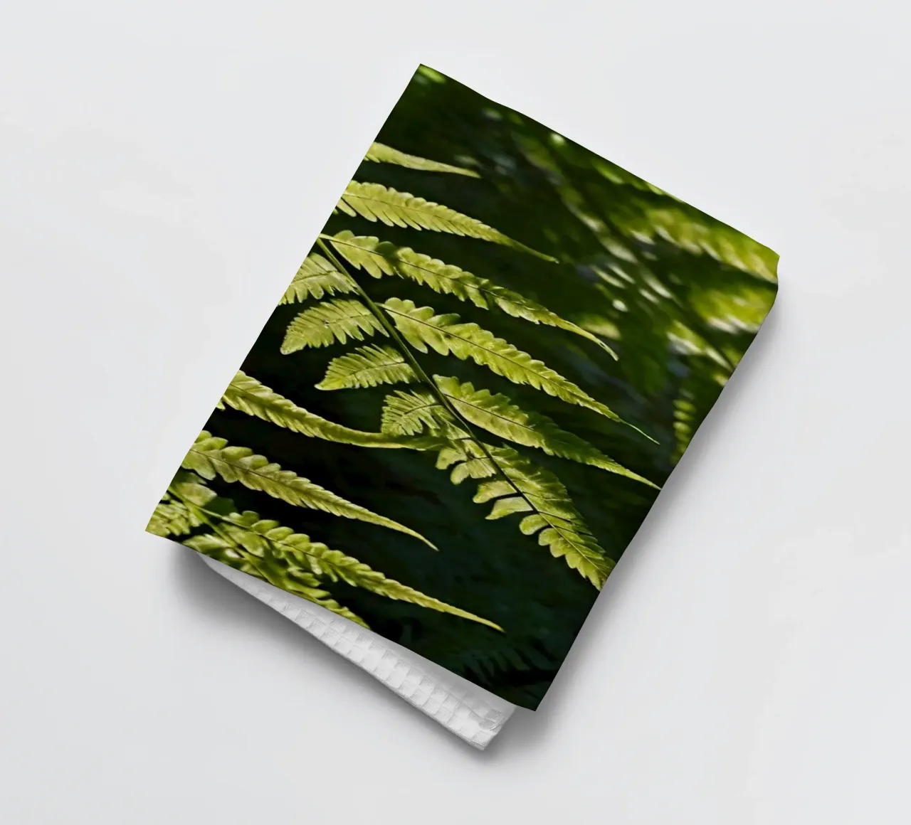 Sunlight filters through lush green ferns in a tranquil fore tea towel by DesignDoodle