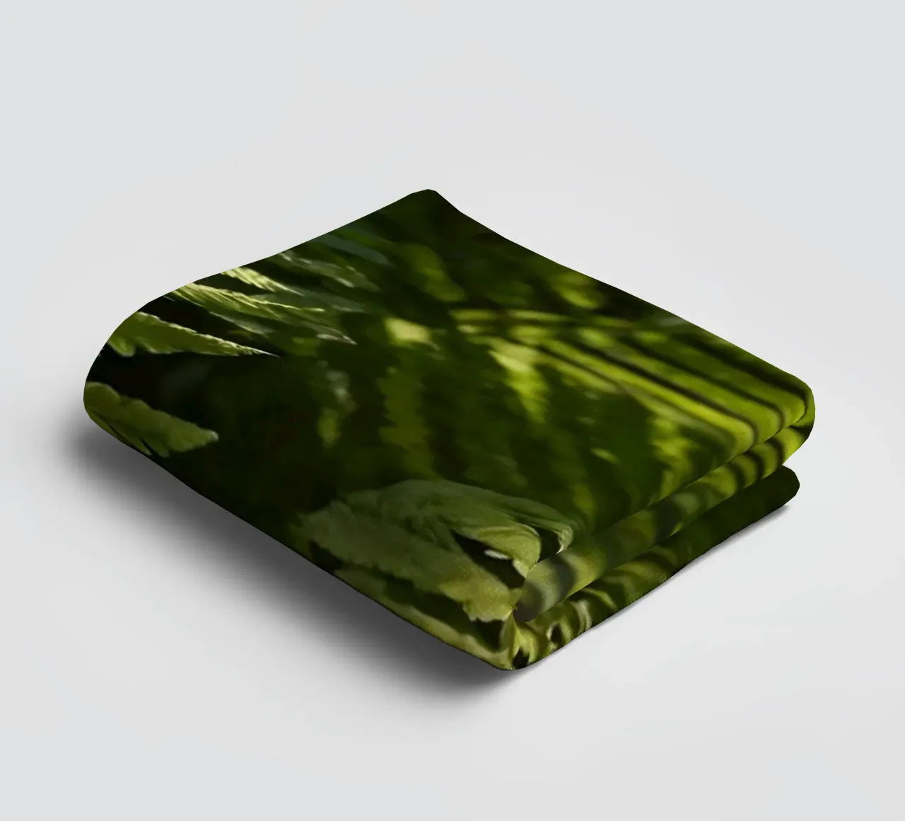 Lush green ferns basking in soft sunlight in a serene forest towel by DesignDoodle