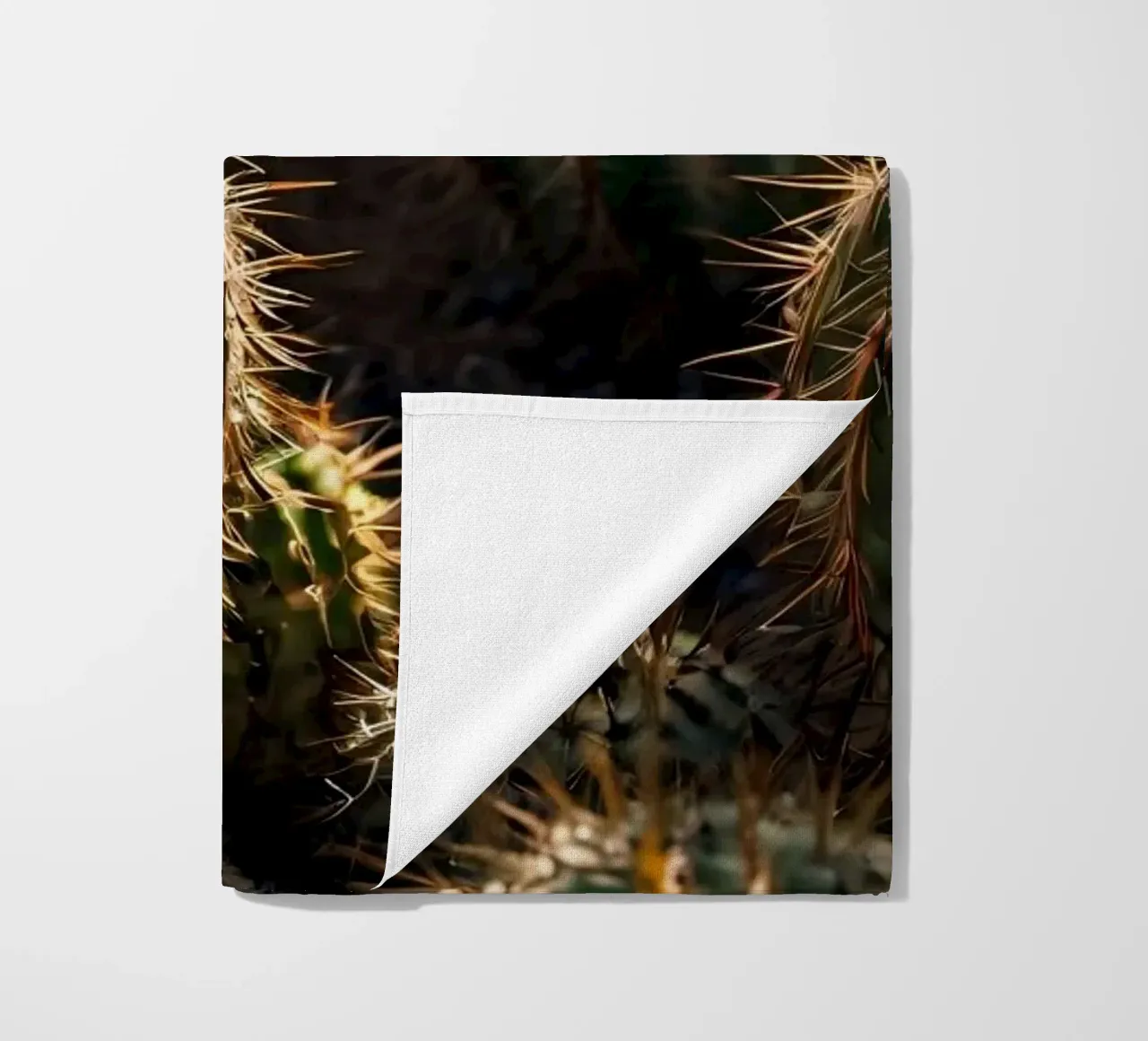 Close-up view of vibrant cacti with prominent spines beach towel by DesignDoodle