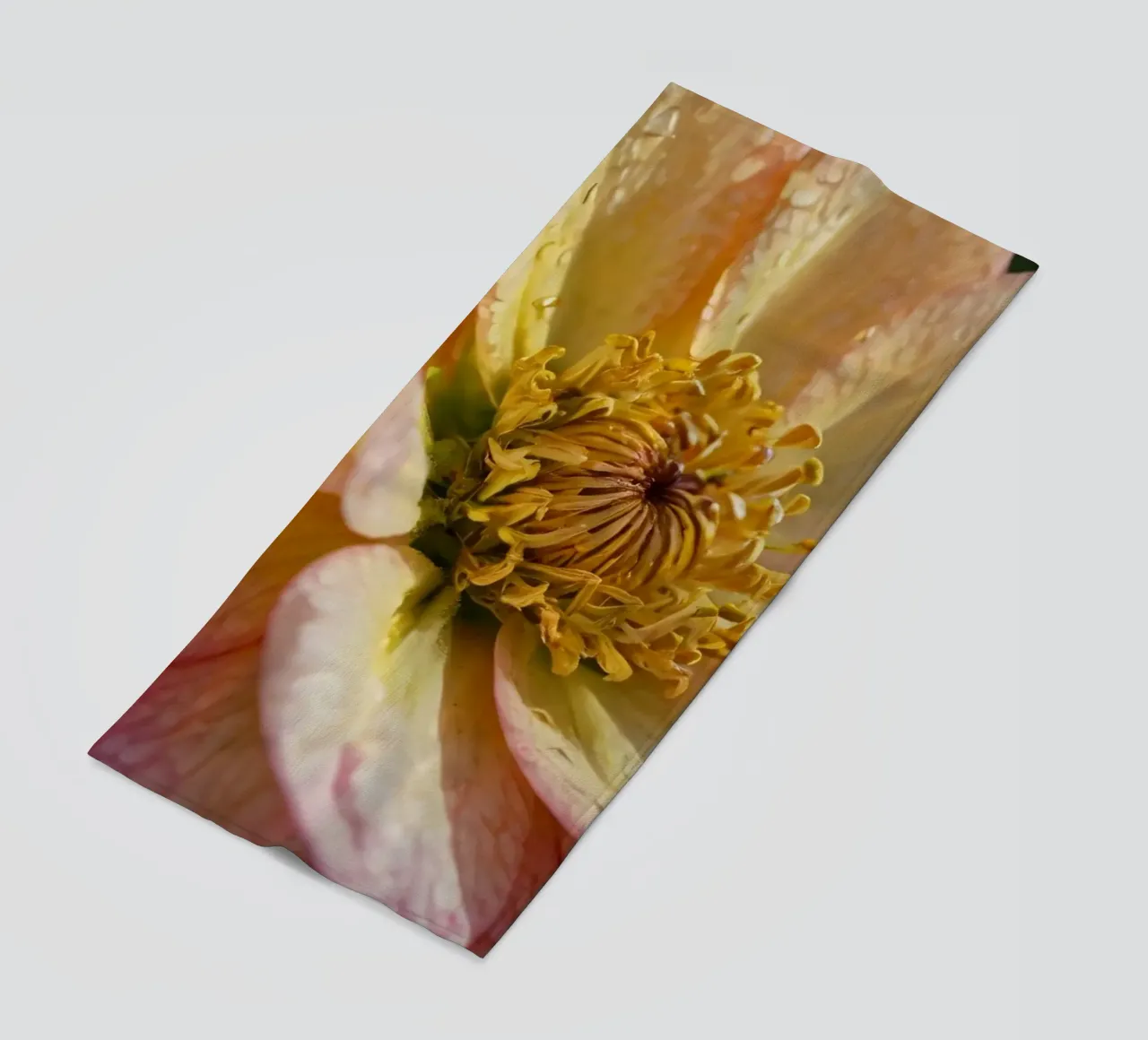 A close-up view of a vibrant flower in a garden beach towel by DesignDoodle