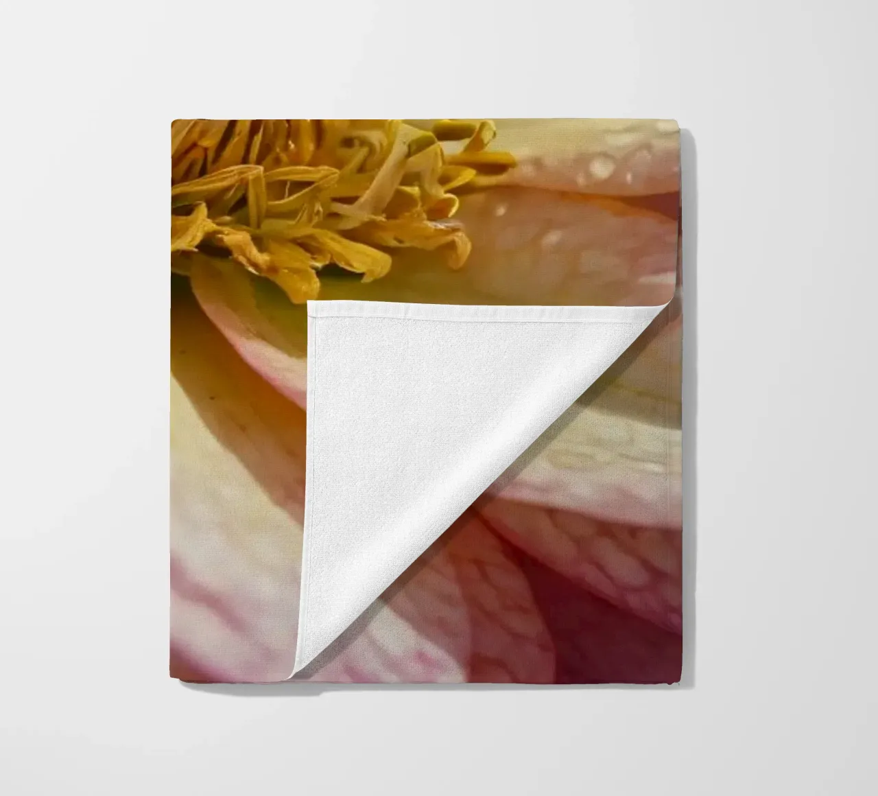 A close-up view of a vibrant flower in a garden beach towel by DesignDoodle