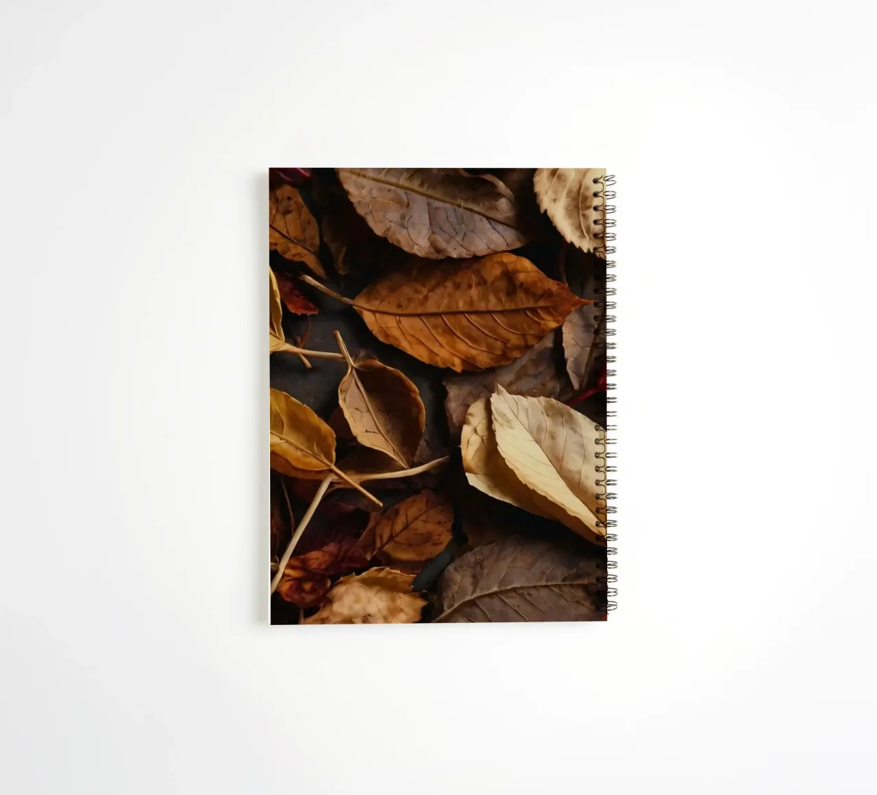 autumn leaves in various shades spread across a dark surface spiral notebook by DesignDoodle
