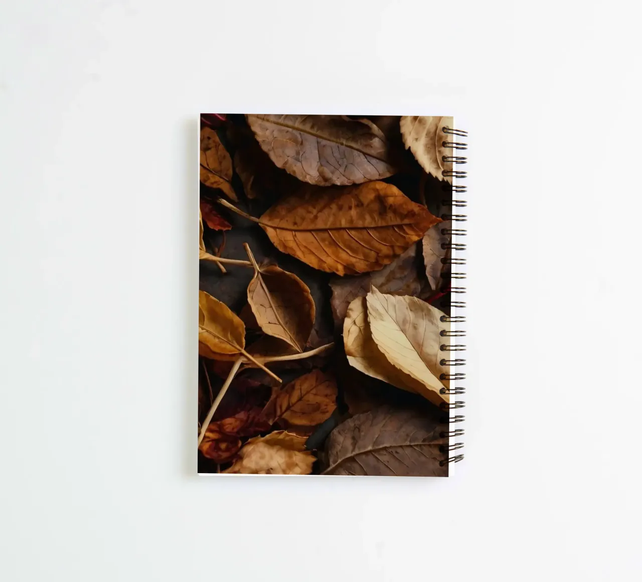 autumn leaves in various shades spread across a dark surface spiral notebook by DesignDoodle