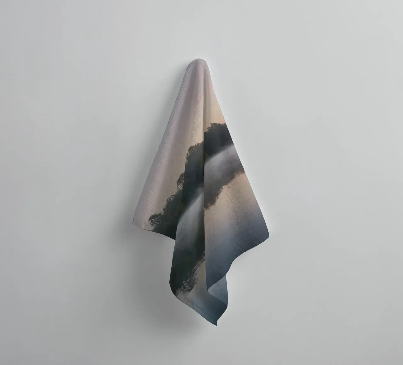 mist rises over a tranquil lake surrounded by lush trees towel by DesignDoodle