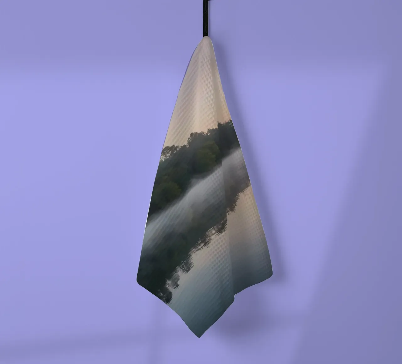 mist rises over a tranquil lake surrounded by lush trees tea towel by DesignDoodle