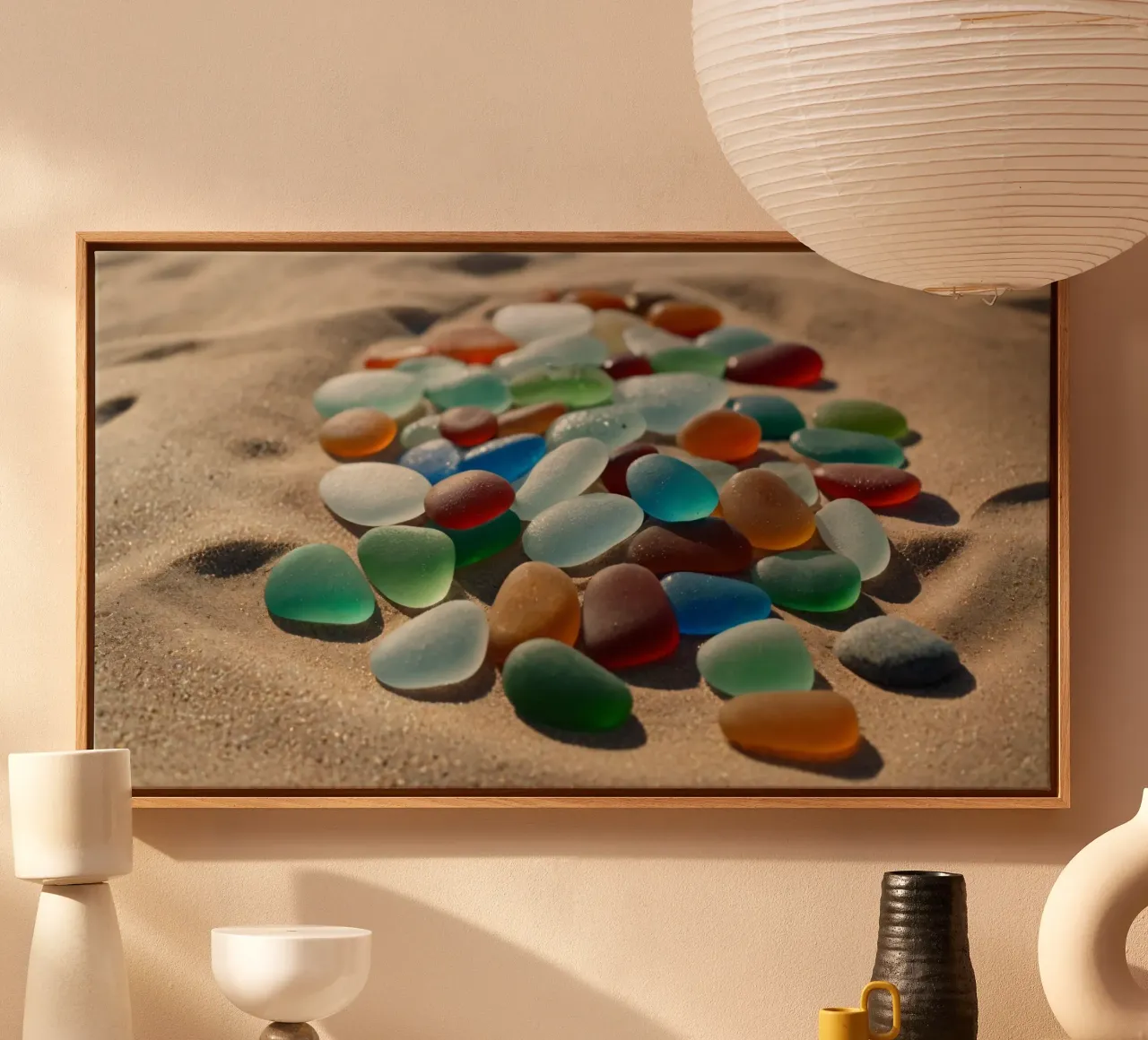 Colorful gems pebbles scattered across sandy beach shoreline canvas by DesignDoodle