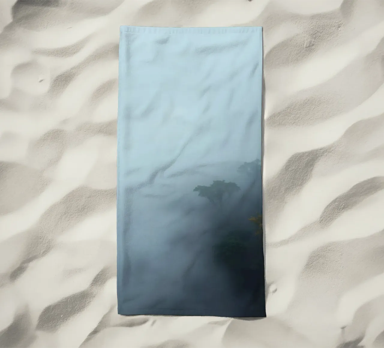 Misty forest landscape with trees emerging through fog beach towel by DesignDoodle