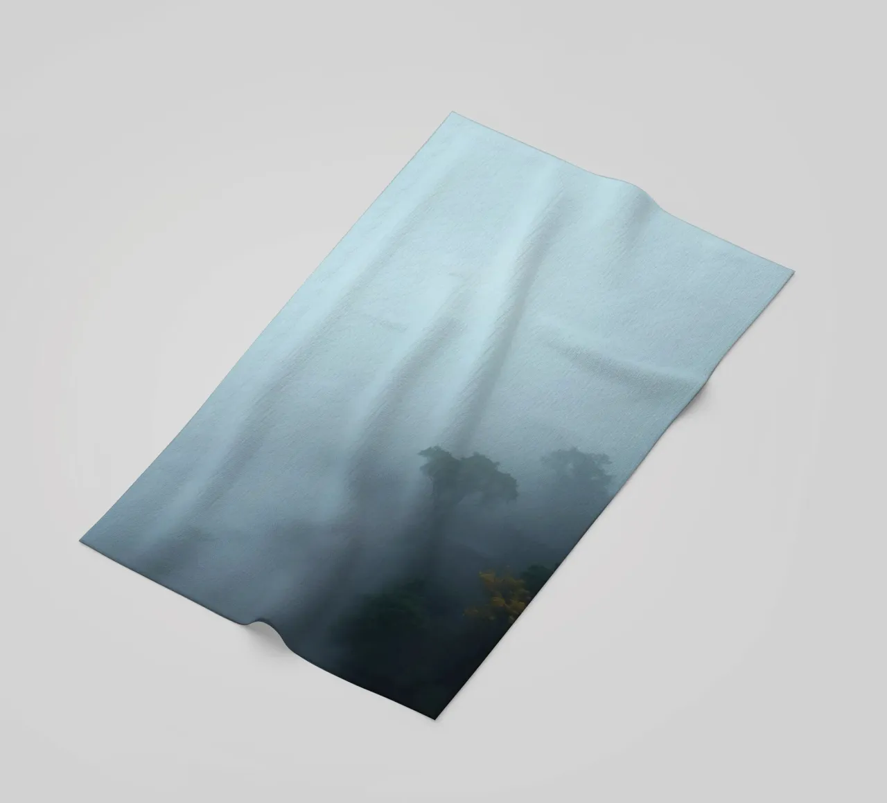 Misty forest landscape with trees emerging through fog beach towel by DesignDoodle