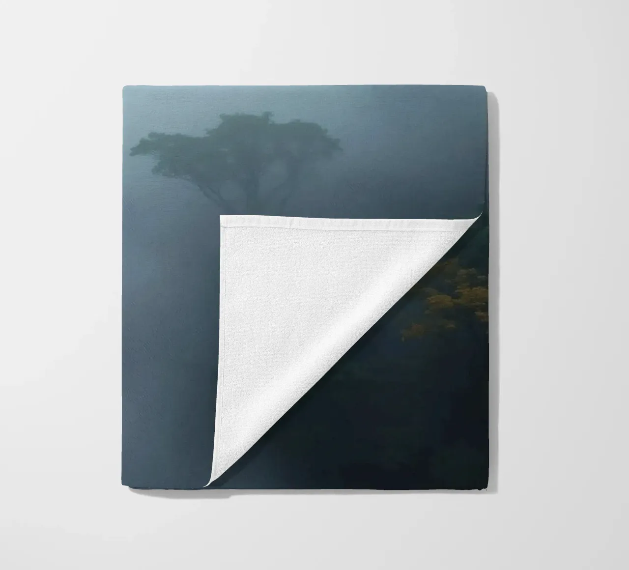 Misty forest landscape with trees emerging through fog beach towel by DesignDoodle