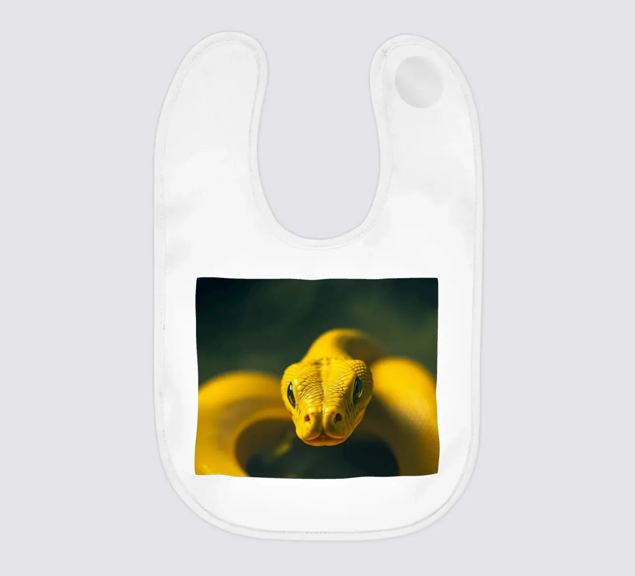 A close-up view of a vibrant yellow snake curving baby bib by DesignDoodle