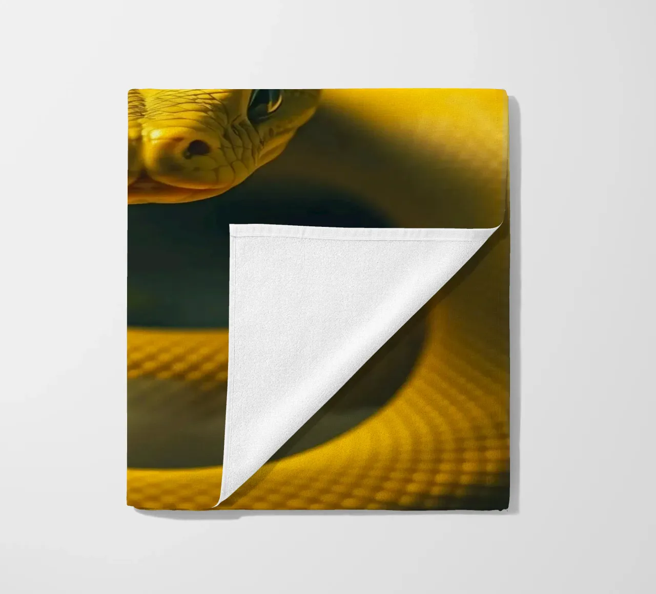 A close-up view of a vibrant yellow snake curving beach towel by DesignDoodle