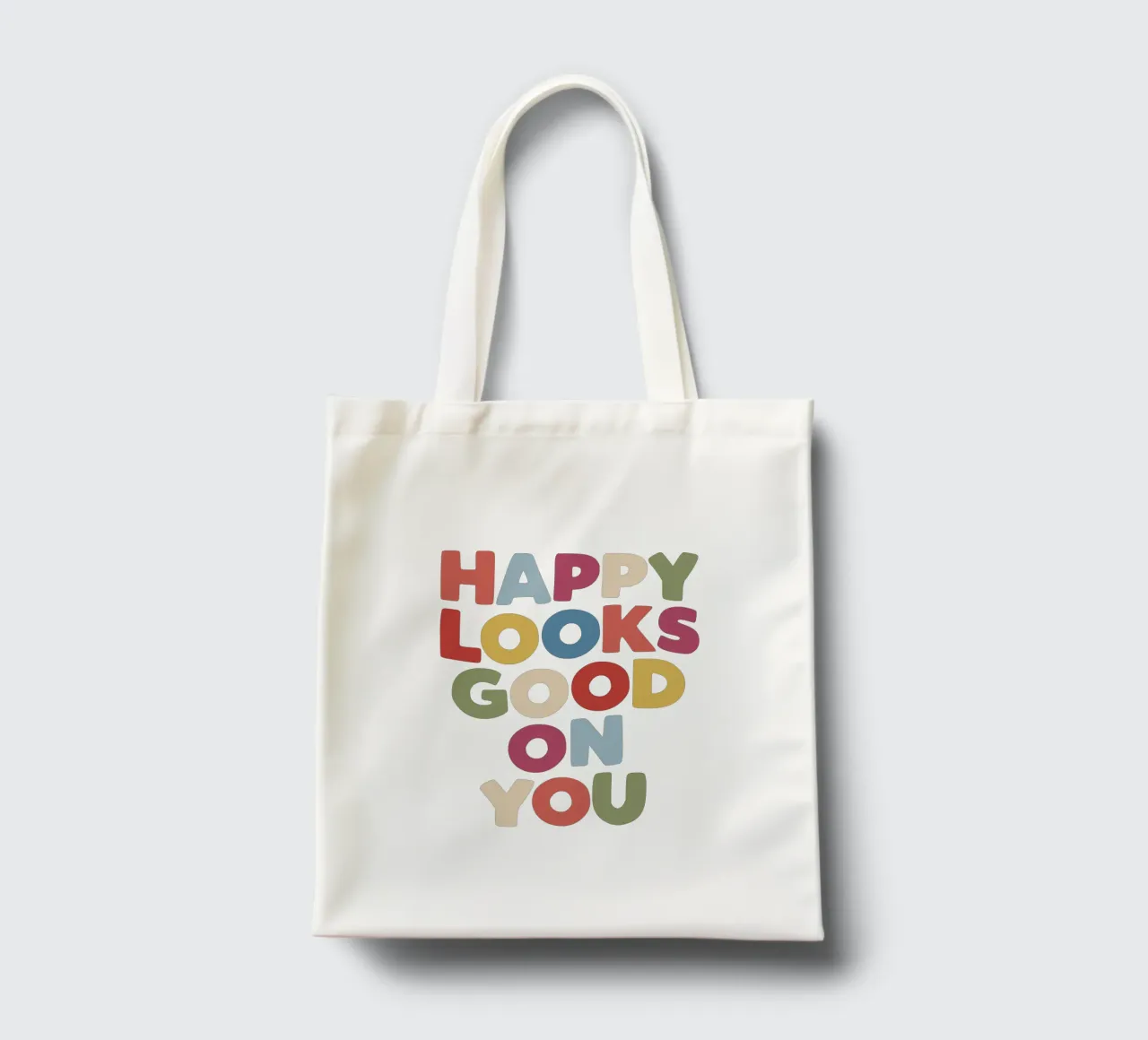 Happy Looks Good on You Vibranti scritte colorate e allegre borsa in juta da THE MOTIVATED TYPE