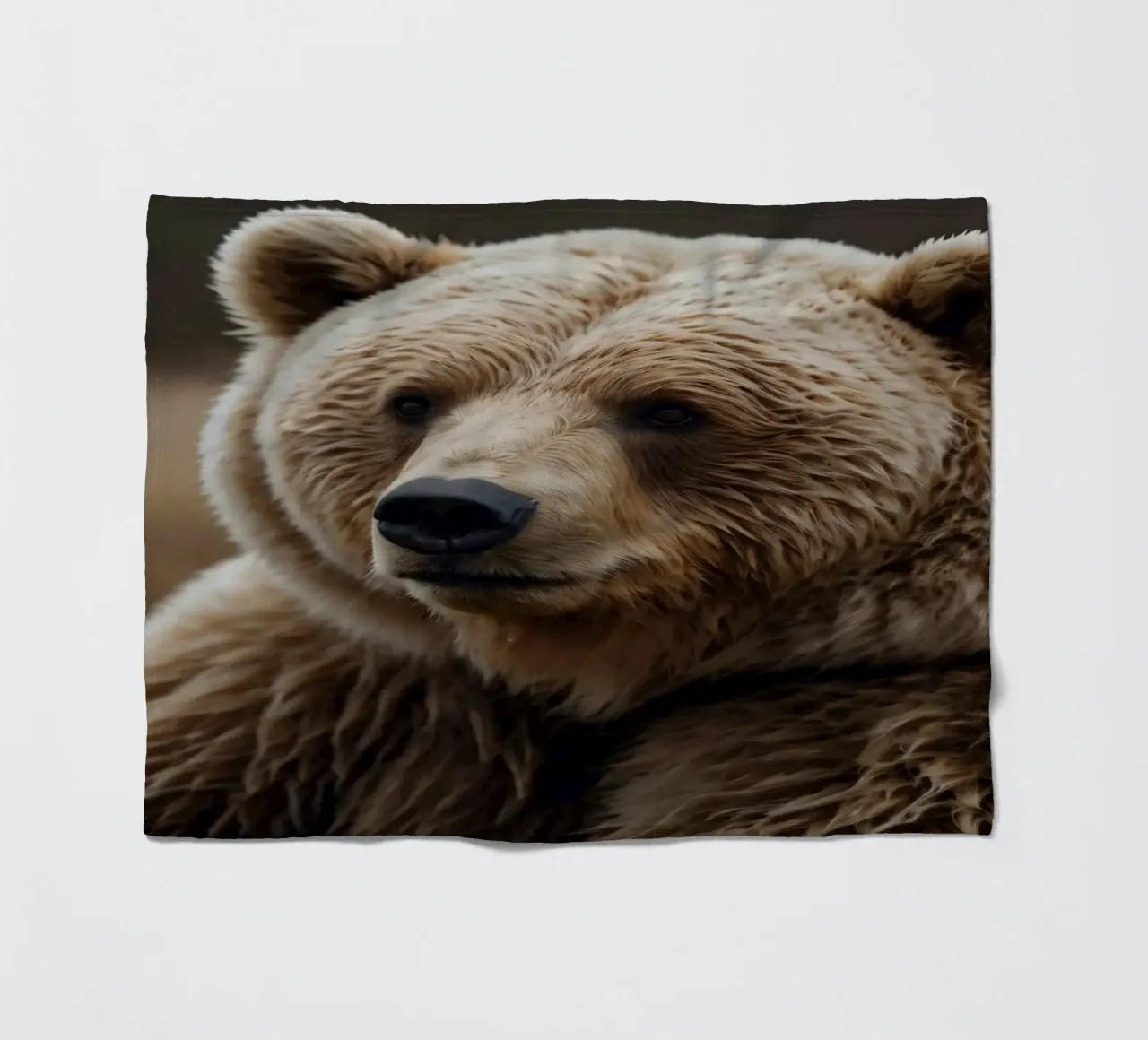 A close-up view of a brown bear resting in a grassy field fleece blanket by DesignDoodle