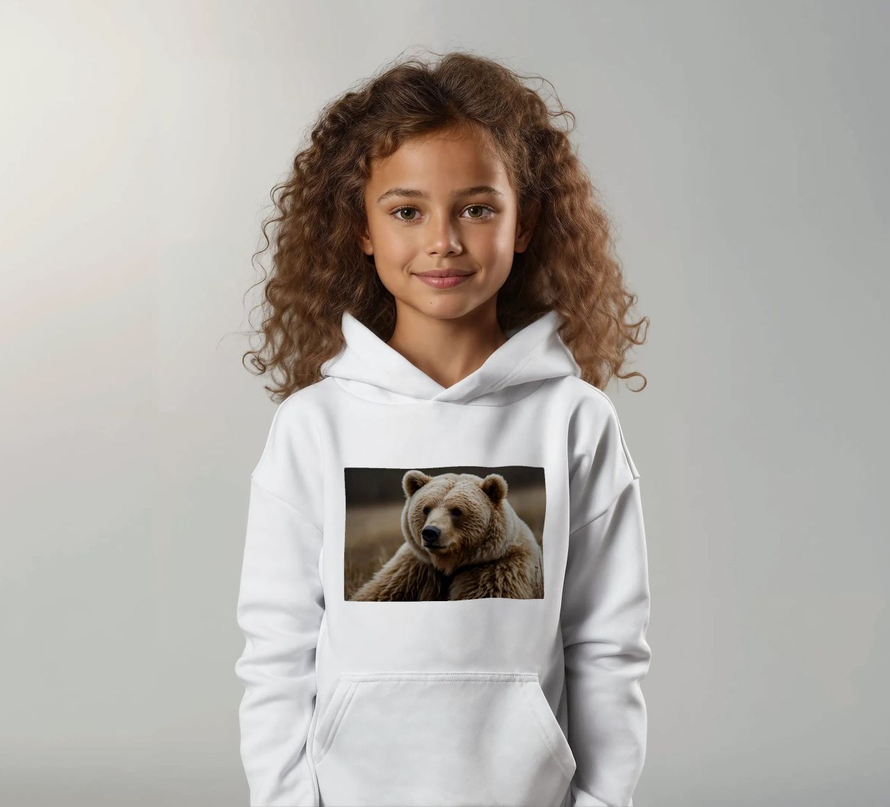 Vue rapprochée d'un ours brun se reposant dans un champ herbeux. sweat à capuche enfant de DesignDoodle
