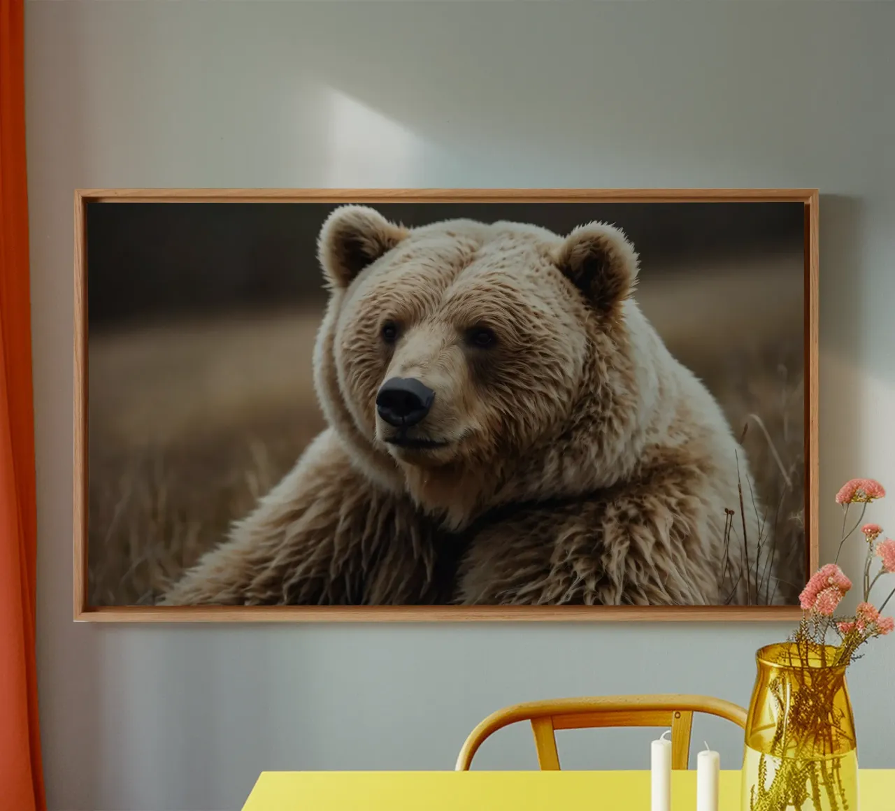 A close-up view of a brown bear resting in a grassy field canvas by DesignDoodle