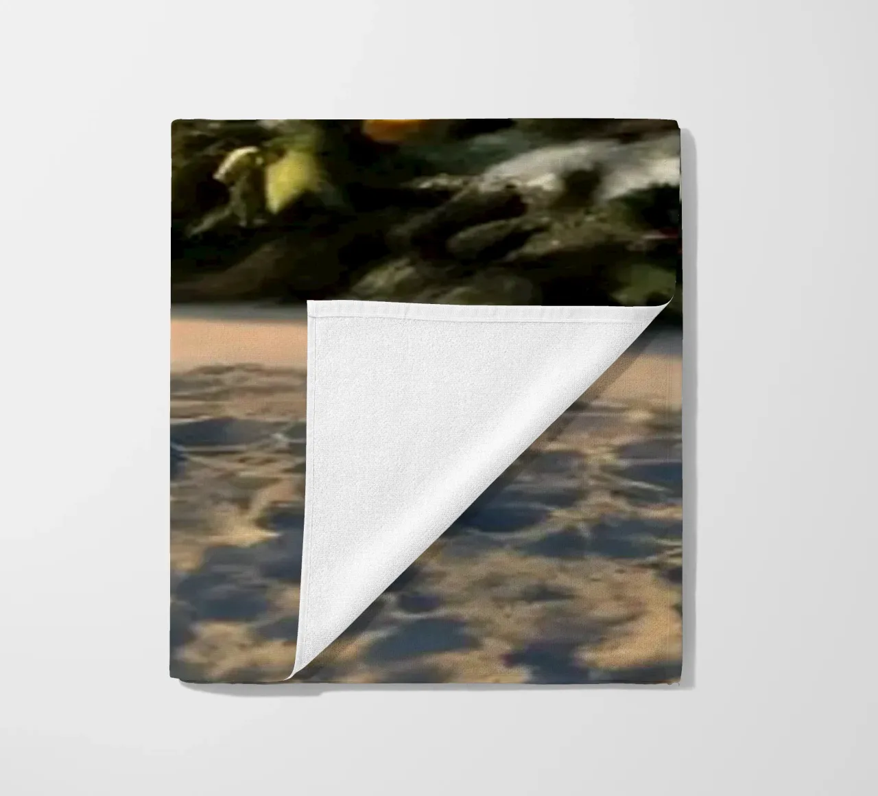 Snow-covered landscape featuring a decorated Christmas tree beach towel by DesignDoodle