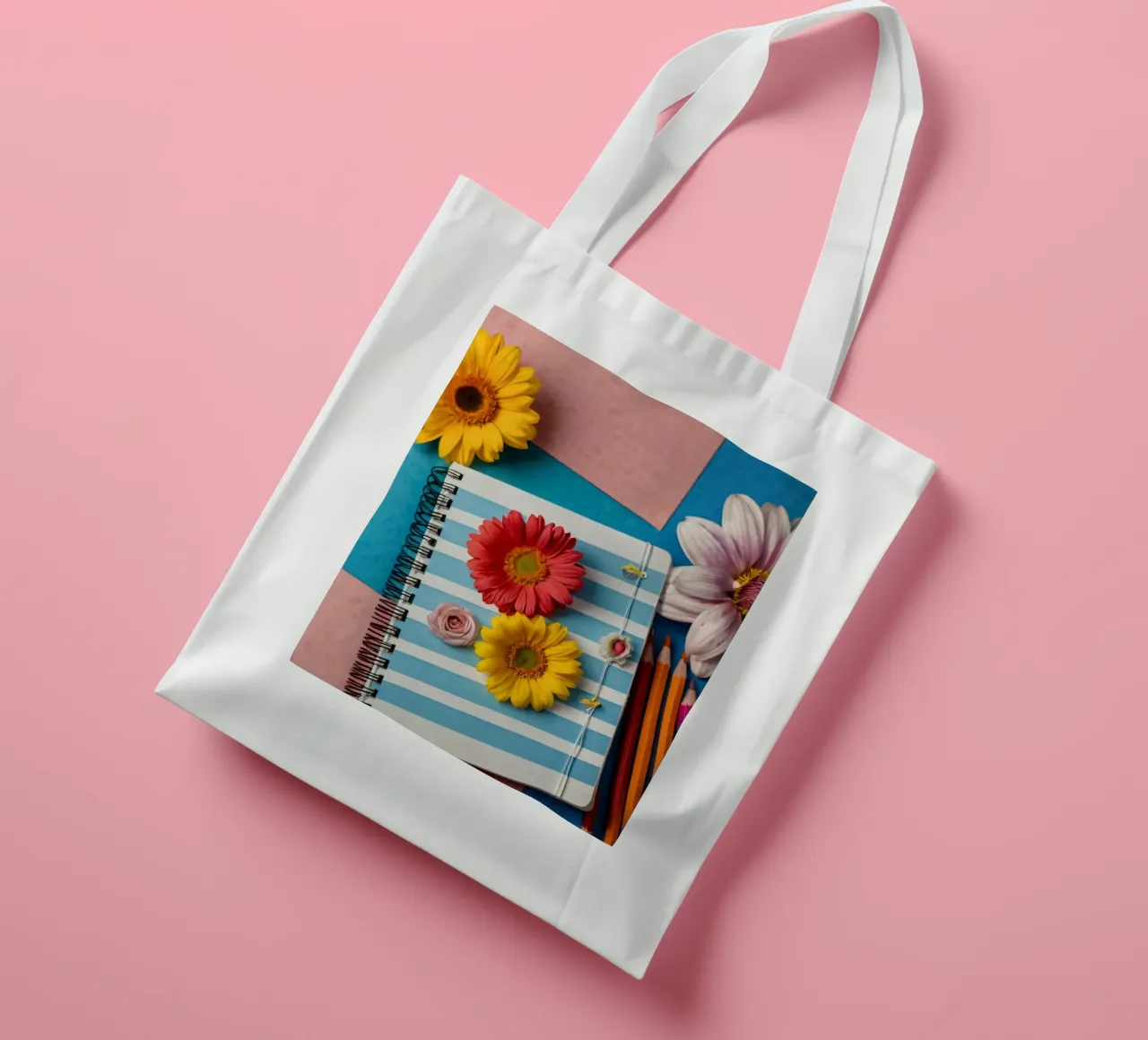 Colorful notebook adorned with flowers surrounded by pencils tote bag by DesignDoodle
