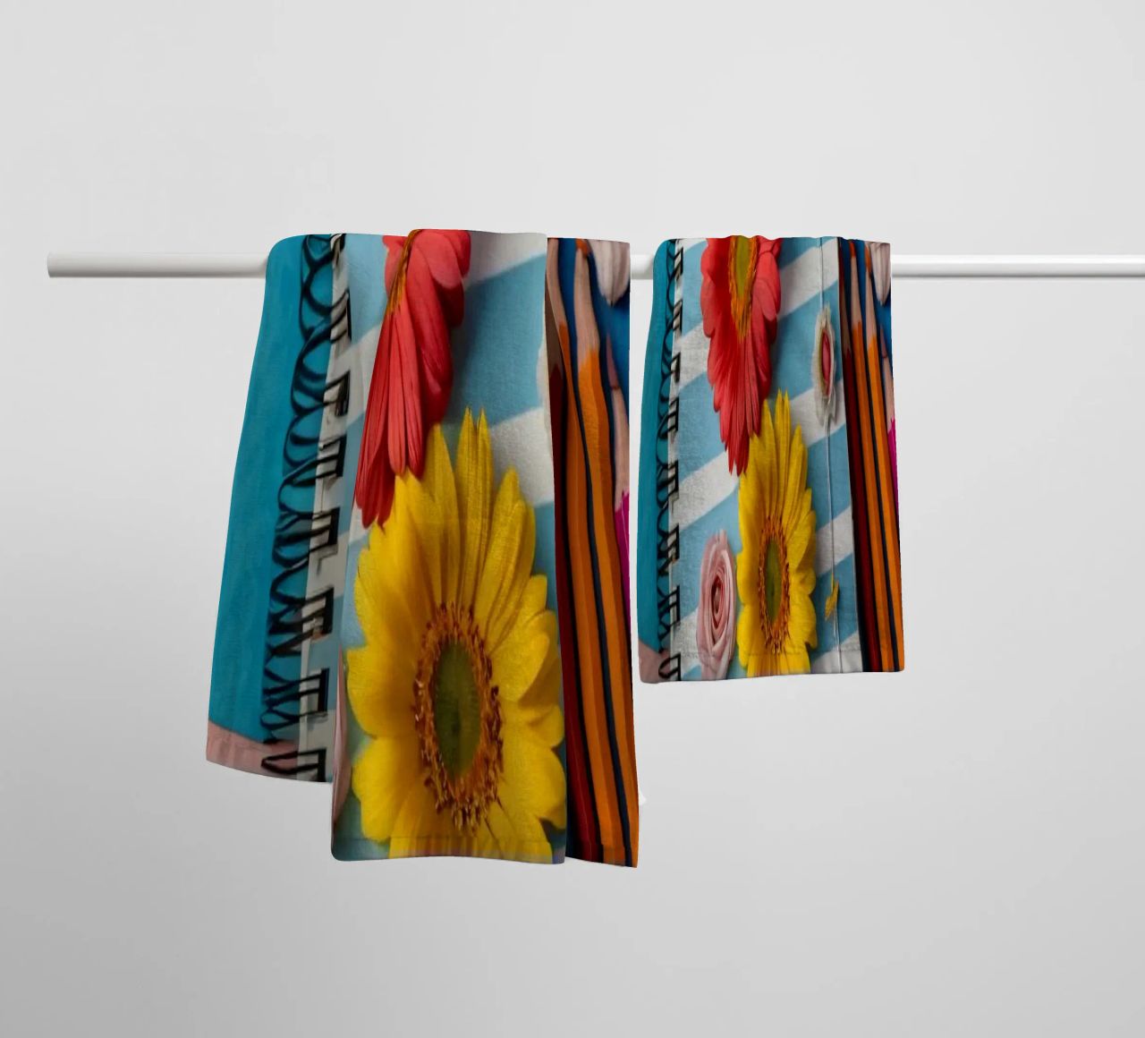 Colorful notebook adorned with flowers surrounded by pencils towel by DesignDoodle