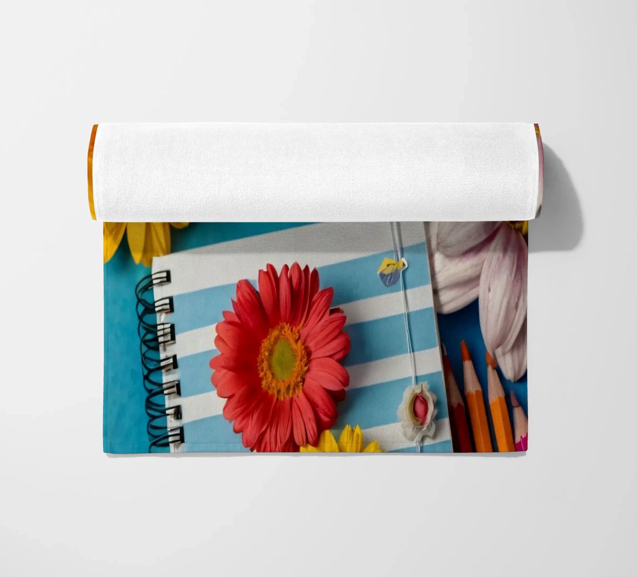 Colorful notebook adorned with flowers surrounded by pencils beach towel by DesignDoodle