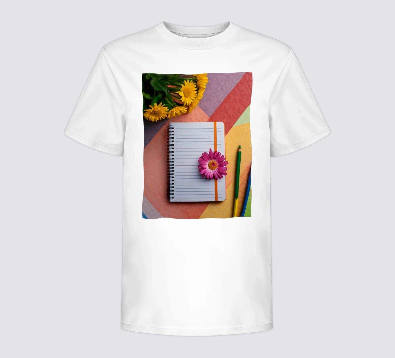 Uno spazio di lavoro colorato con un taccuino con un fiore t-shirt bambini da DesignDoodle