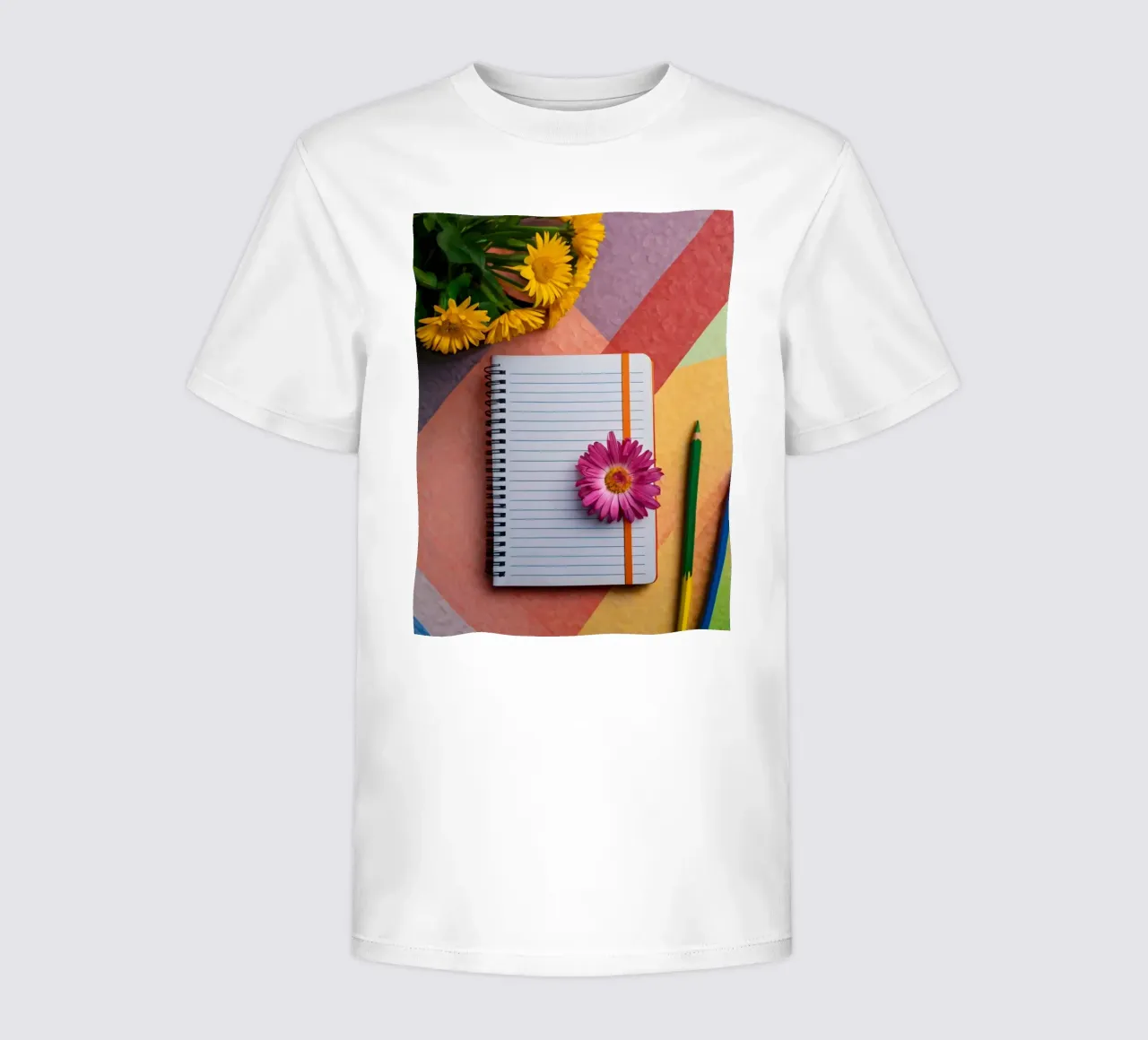 Uno spazio di lavoro colorato con un taccuino con un fiore t-shirt bambini da DesignDoodle