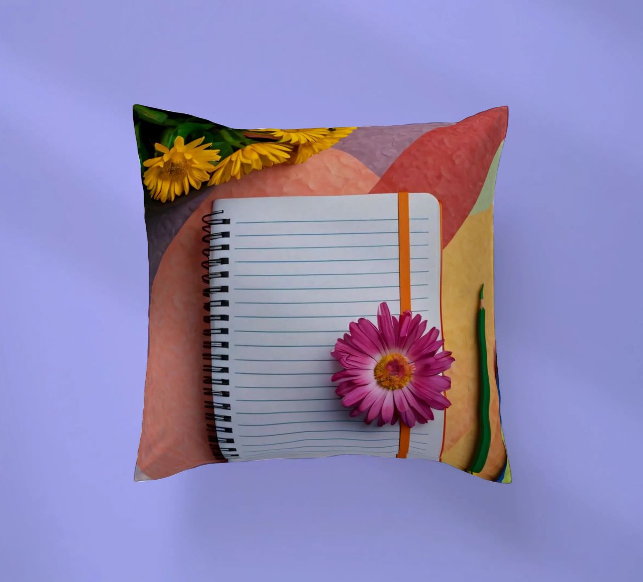Uno spazio di lavoro colorato con un taccuino con un fiore cuscino da DesignDoodle